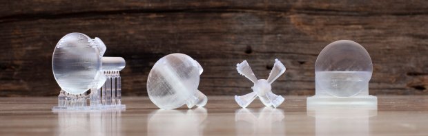 Left to right: (1) Lens printed with supports in clear resin with 50 micron layers. “Housing” connected to lens with 12 x 1mm thickLA posts has 6mm rod to fit into cordless drill. (2) Convex side of lens polished. (3) Housing removed. (4) Press fit housing to polish flat side of lens.