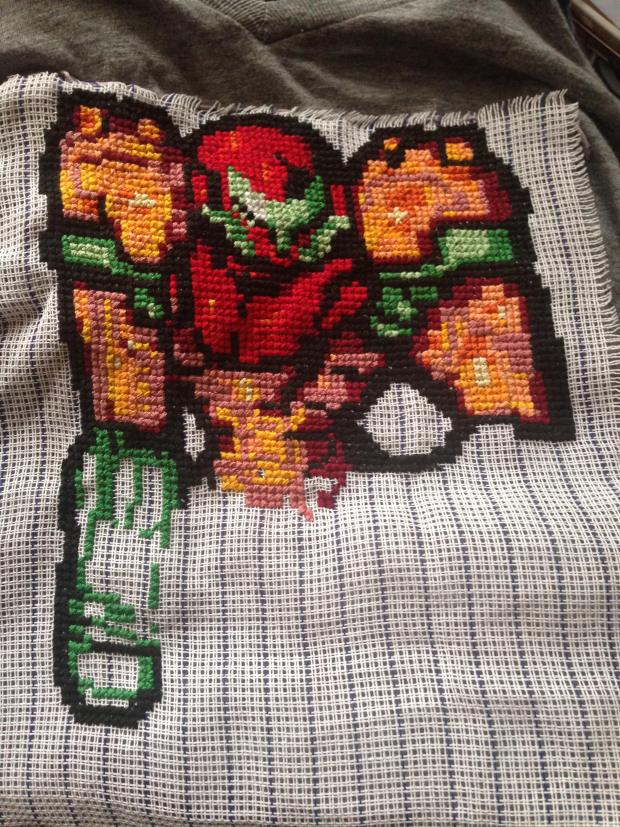 The tricky part of putting a cross-stitched image on a t-shirt is getting rid of the waste canvas, which has to be carefully cut away without damaging the threads.