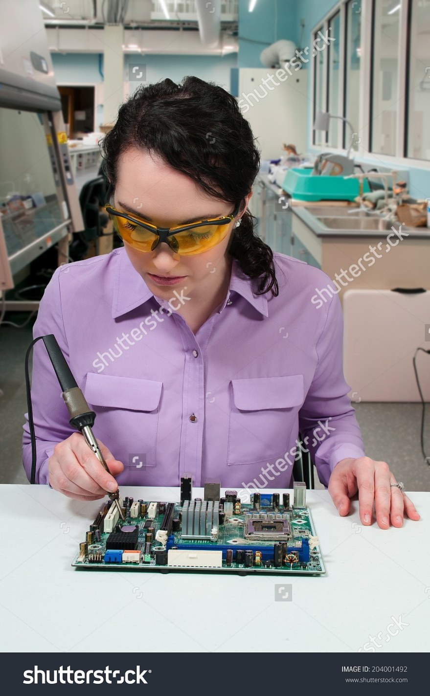 stock-photo-beautiful-woman-repair-soldering-a-printed-circuit-board-204001492
